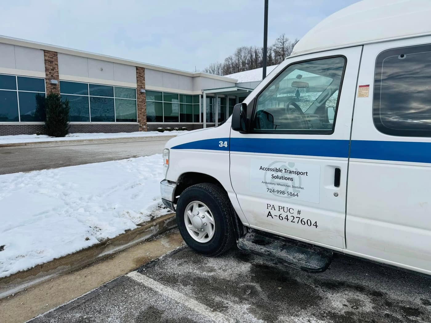 Side of an ATS van showing the company name, phone number, and PA PUC number