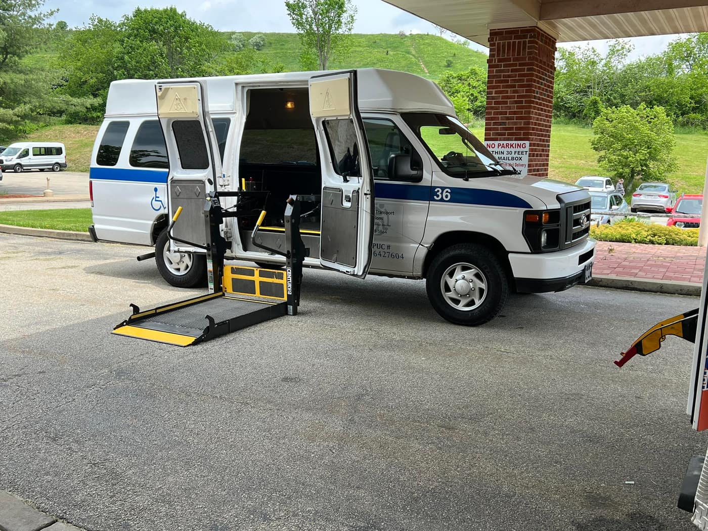 ATS van with its wheelchair lift lowered outside a facility entrance